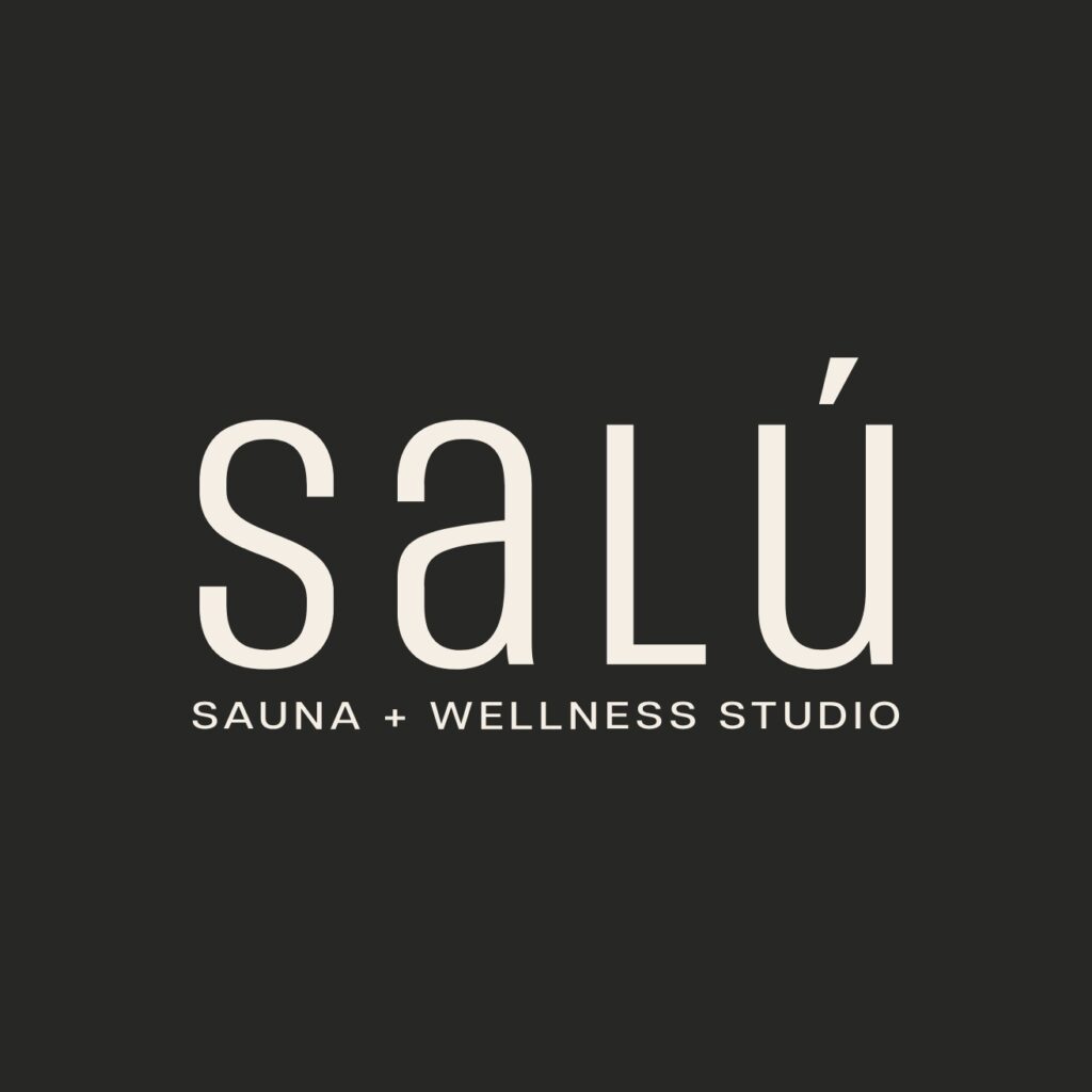 The logo for Salu Sauna + Wellness Studio, featuring a black background and creme lettering.