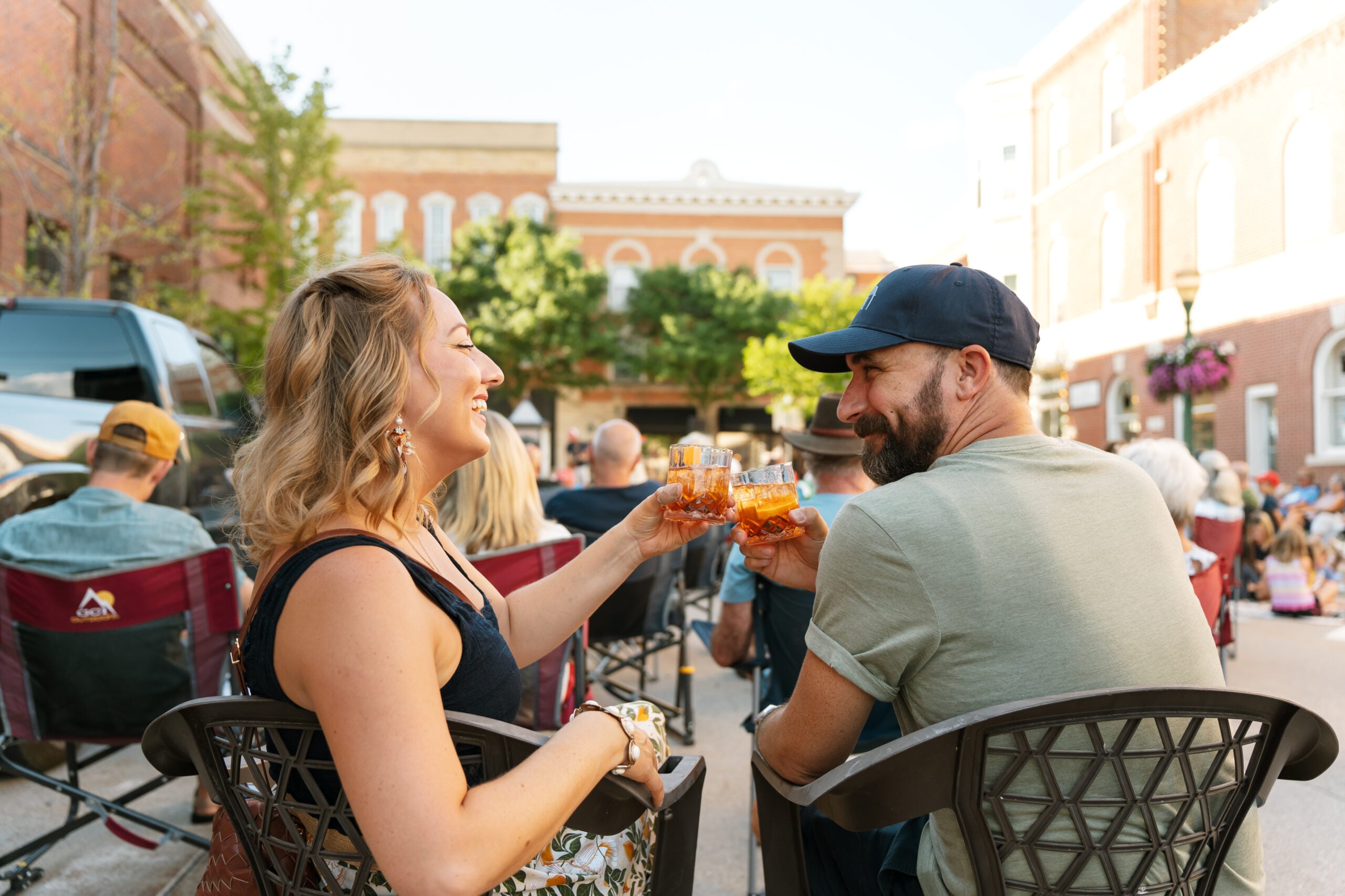 Couple with drinks at an outdoor venue in Downtown Decorah